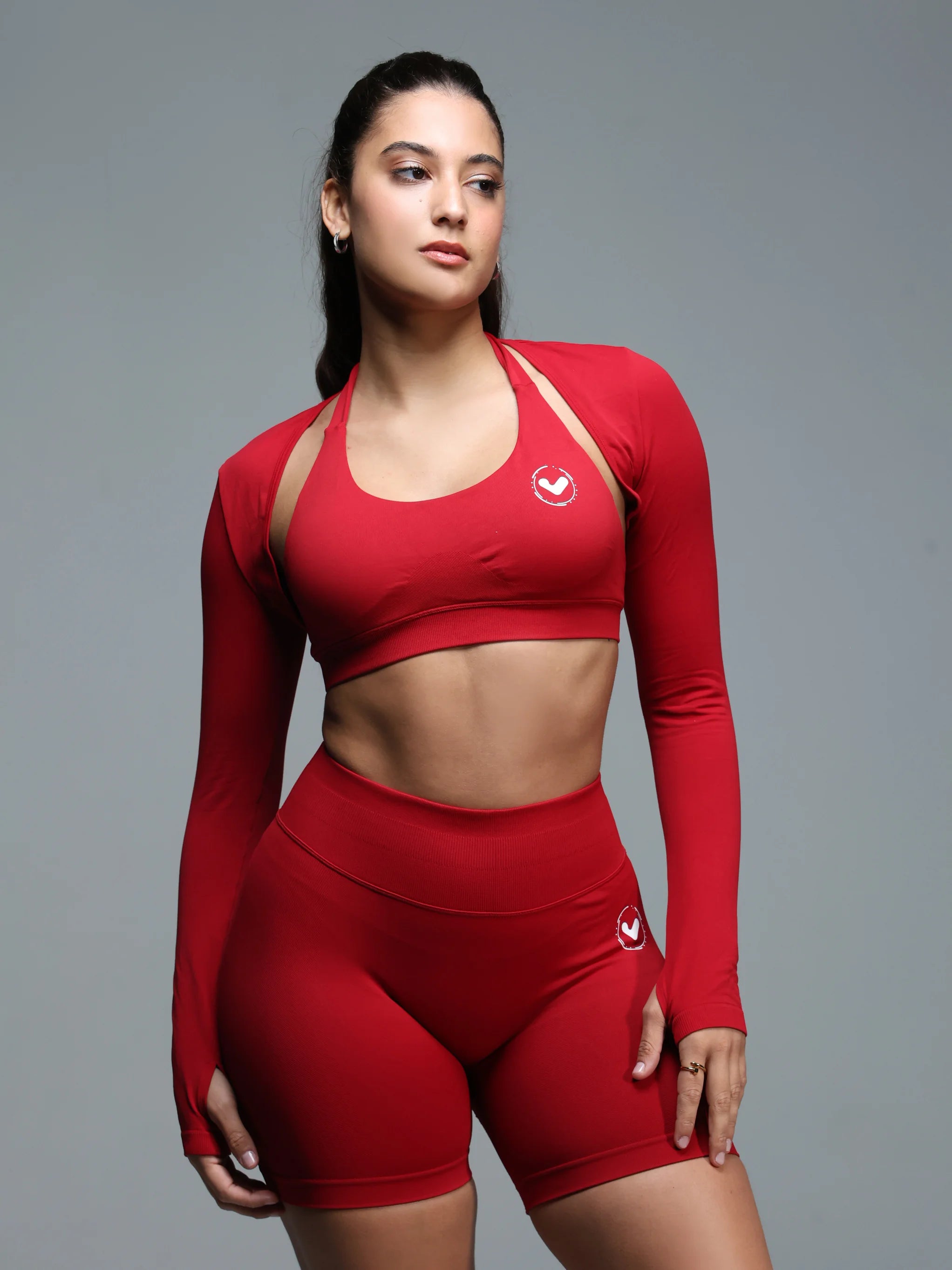 Woman wearing a red athletic outfit with a gray background