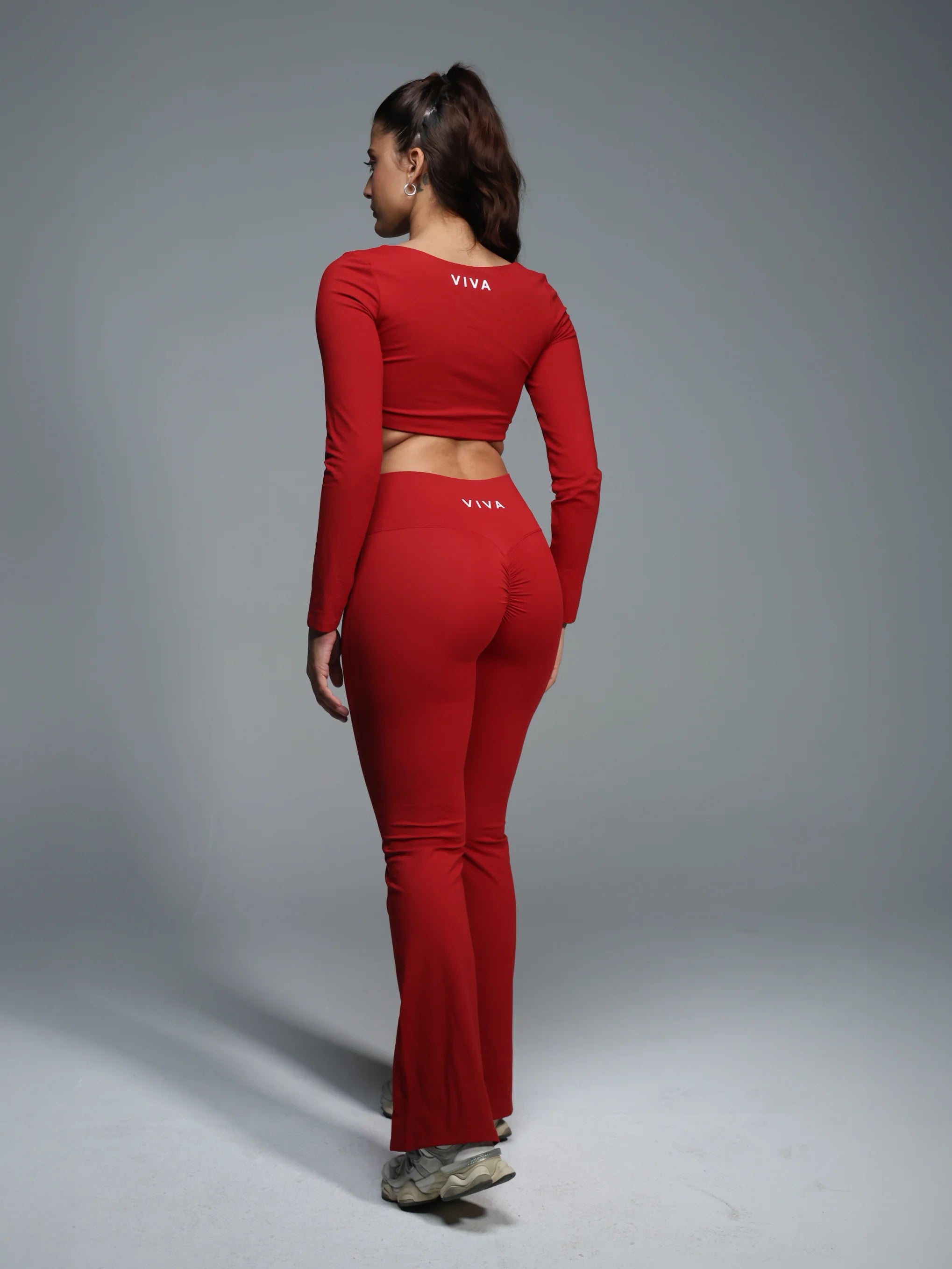 Person wearing a red outfit with 'VIVA' branding on a gray background